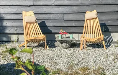 two chairs and a coffee table in front of a house at Beautiful Home In Vøringsfoss With Wifi in Maurset