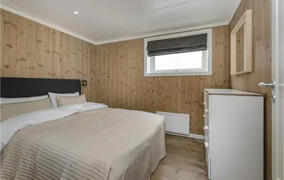 a bedroom with a large bed and a window at Sjusjøen Setergrend 4724 B in Sjusjøen
