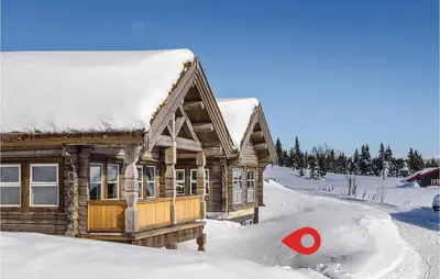 a log cabin in the snow with a red target at Sjusjøen Setergrend 4724 C in Sjusjøen