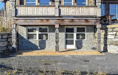 a brick house with a door and a balcony at Sjusjøen Setergrend 4724 C in Sjusjøen
