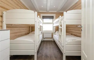 a bedroom with two bunk beds in a house at Lovely Home In Sjusjøen With Sauna in Sjusjøen
