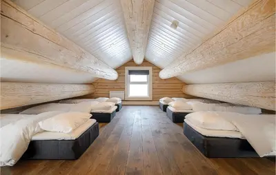 a room with a bunch of beds in it at Lovely Home In Sjusjøen With Sauna in Sjusjøen