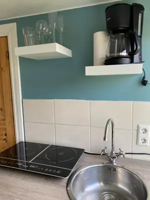 a kitchen counter with a sink and a coffee maker at 1-rom Apartment Sommer - Frøya in Sætra