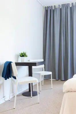 a table and two chairs in a room with a window at Slottet Apartments in Tysso