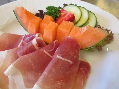 a plate of food with fruits and vegetables on it at Lavik Fjord Hotel & Apartments in Lavik