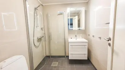 a bathroom with a shower and a sink and a toilet at Geilolia Ferieleiligheter in Geilo