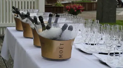 a table topped with wine glasses and wine bottles at Angvik Gamle Handelssted - by Classic Norway Hotels in Angvik