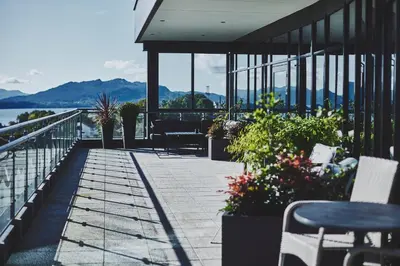 a patio with chairs and a view of the water at Stord Hotel in Stord