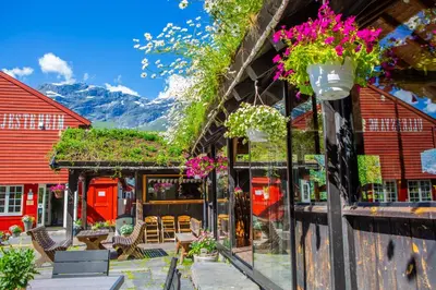 a restaurant with flowers on the side of a building at Ullensvang Gjesteheim in Lofthus
