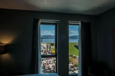 a bedroom with a window with a view of a city at Hardangerfjord Hotel in Øystese
