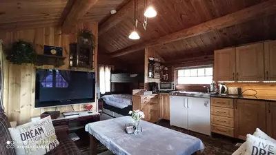 a room with a kitchen and a living room at Suigard Smia in Sauland