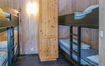a room with two bunk beds in a wooden cabin at Cozy Apartment In Hemsedal With Sauna in Hemsedal