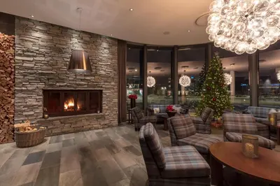 a lobby with a christmas tree and a fireplace at Quality Hotel Skifer in Oppdal