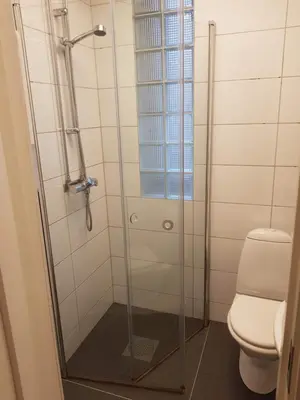a glass shower in a bathroom with a toilet at City Hostel Bergen in Bergen