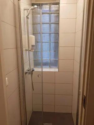 a shower stall with a window in a bathroom at City Hostel Bergen in Bergen