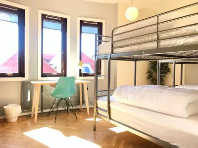 a bedroom with a bunk bed and a desk at City Hostel Bergen in Bergen