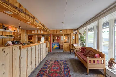 a living room with a couch and a table at Lillehammer Fjellstue og Hytteutleie in Nordseter