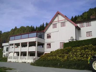 a large white building with a red roof at Kroderen Kro & motel AS in Hamremoen