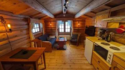 a kitchen and living room of a log cabin at Weistad in Heidal