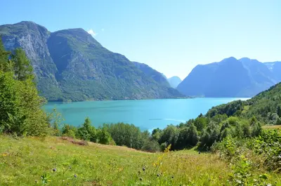 a view of a lake with mountains in the background at Tunold Gård - Gamle huset in Mindresunde