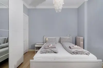 a white bedroom with a bed with two pillows at Apartment with Beautiful View to Bryggen in Bergen