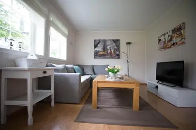 a living room with a couch and a table at Apartment at Ranheim in Trondheim