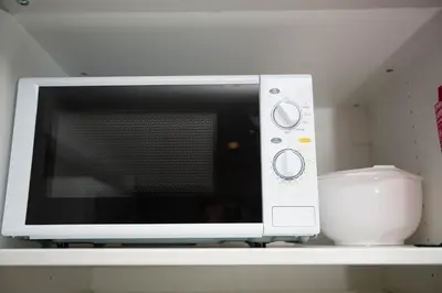 a microwave oven sitting on a shelf with a bowl at Apartment at Ranheim in Trondheim