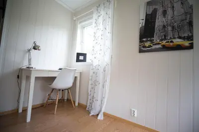 a desk and a chair in a room with a window at Apartment at Ranheim in Trondheim
