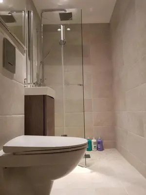 a bathroom with a toilet and a glass shower at Apartment at Ranheim in Trondheim