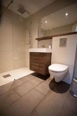 a bathroom with a toilet and a sink and a shower at Apartment at Ranheim in Trondheim