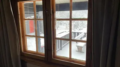 a window with a view of a snow covered yard at Bjerkely, Sjusjøen in Sjusjøen
