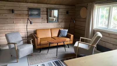 a living room with a couch and two chairs at Bjerkely, Sjusjøen in Sjusjøen