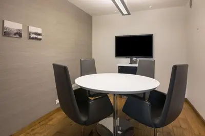 a meeting room with a white table and chairs at Scandic Bakklandet in Trondheim