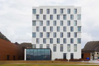 a white building with a lot of windows at Scandic Rock City in Namsos