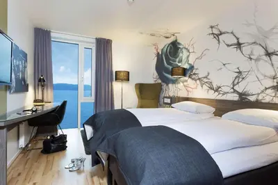 a hotel room with a large bed and a window at Scandic Rock City in Namsos