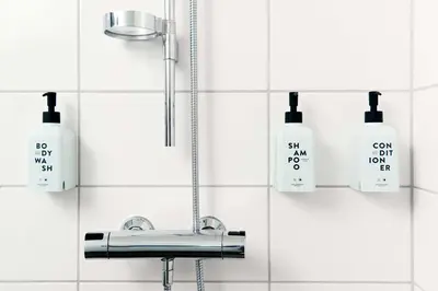 a bathroom with a sink and soap bottles on the wall at Scandic Byparken in Bergen