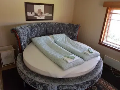 a bed with two towels on it in a room at Leite Gård near Atlantic Road in Hustadvika in Lyngstad