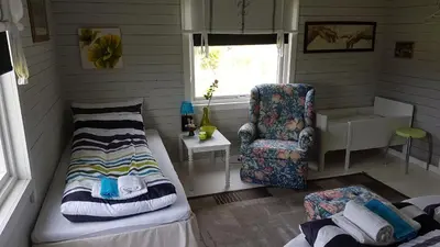 a living room with a couch and a chair at Leite Gård near Atlantic Road in Hustadvika in Lyngstad