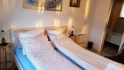 a bed with two pillows on it in a room at Leite Gård near Atlantic Road in Hustadvika in Lyngstad