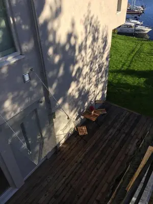 an overhead view of a deck with a shadow on a house at Knudsen Apartment in Bergen