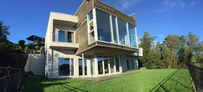 a house with a large lawn in front of it at Knudsen Apartment in Bergen