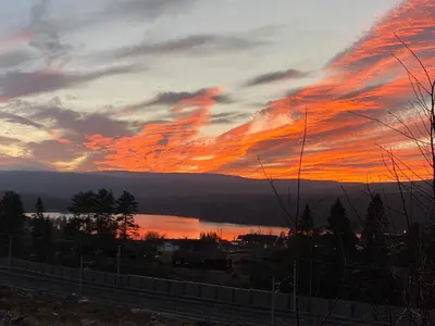 a sunset over a body of water with a cloudy sky at Bed and Breakfast Hadeland in Harestua