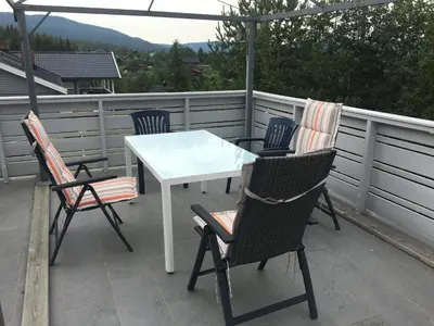 a white table and chairs on a balcony at Bed and Breakfast Hadeland in Harestua