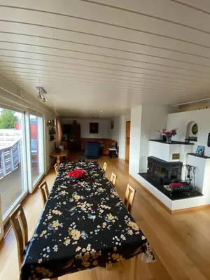 a dining room with a table and a fireplace at Bed and Breakfast Hadeland in Harestua