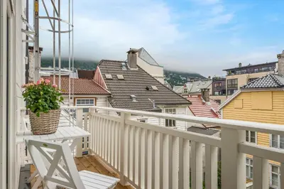 a balcony with a view of the roofs of houses at Fosswinckel Apartments in Bergen