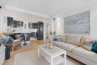 a living room with a couch and a table at Øyjorden Apartment in Bergen