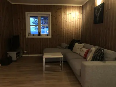 a living room with a couch and a table at Norefjell Panorama in Noresund
