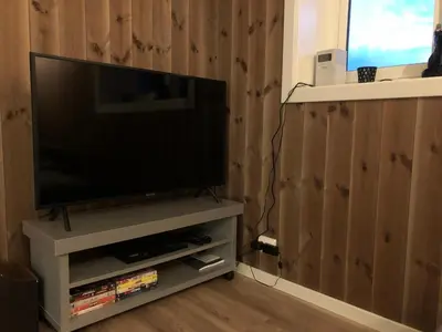 a flat screen tv sitting on a tv stand at Norefjell Panorama in Noresund