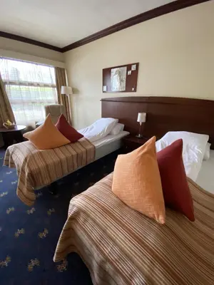 a hotel room with two beds with pillows at Fitjar Fjordhotell in Fitjar