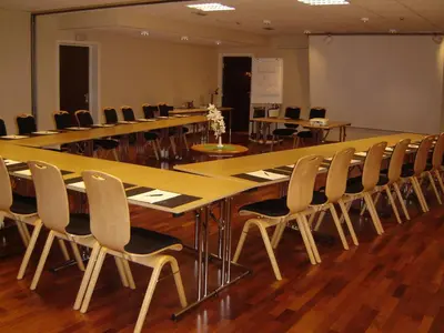 a conference room with a long table and chairs at Fitjar Fjordhotell in Fitjar